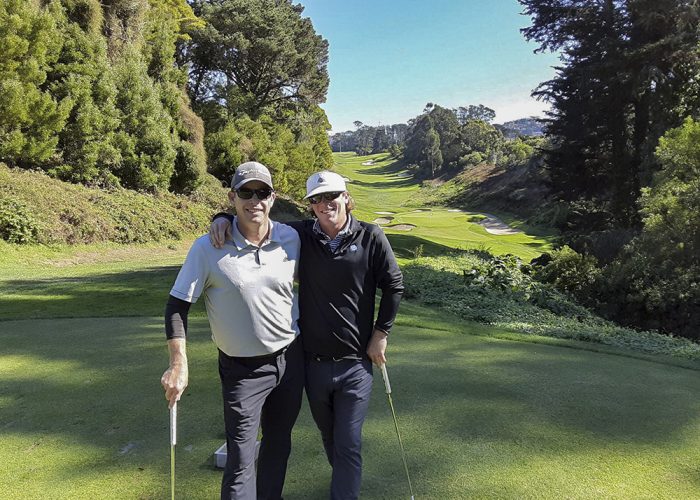 two men posing on golf course
